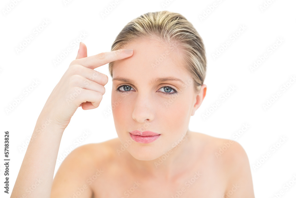 Thoughtful fresh blonde woman pointing her brow with her finger