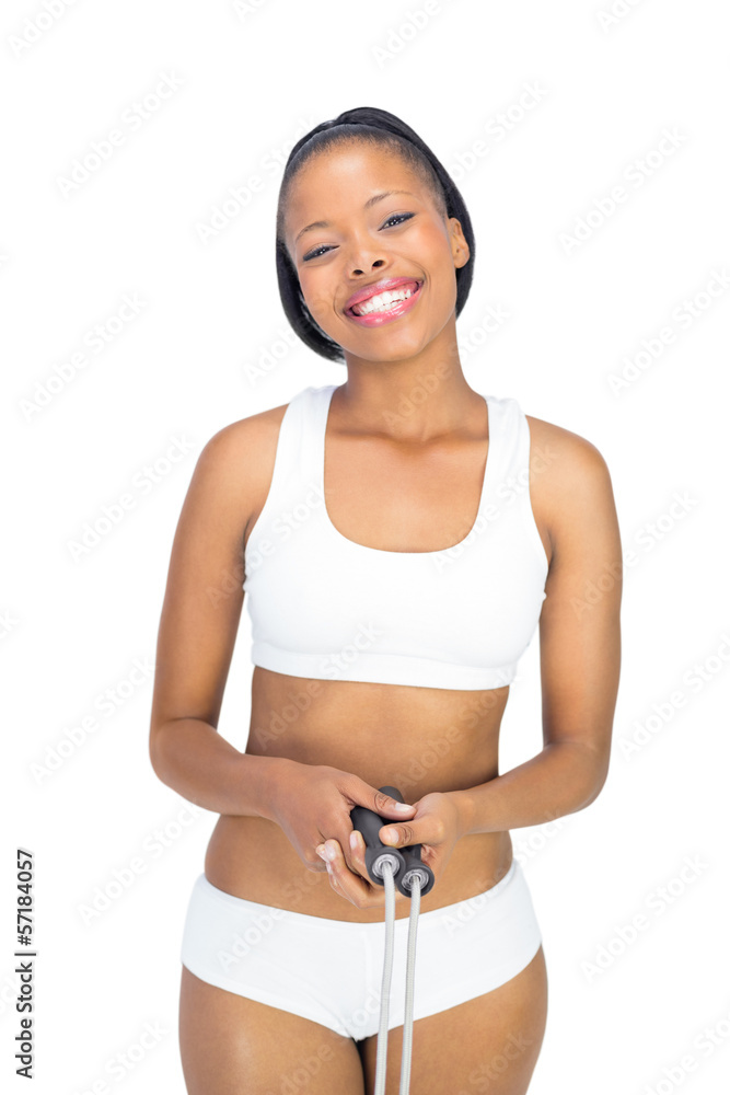 Happy woman in sportswear holding jump rope and smiling at camer Happy woman in sportswear holding jump rope and smiling at camer