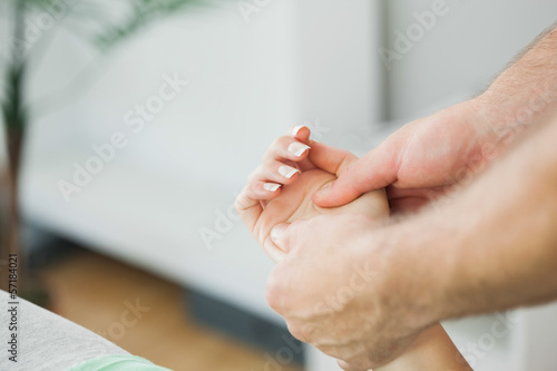 Physiotherapist massaging the hand of a patient