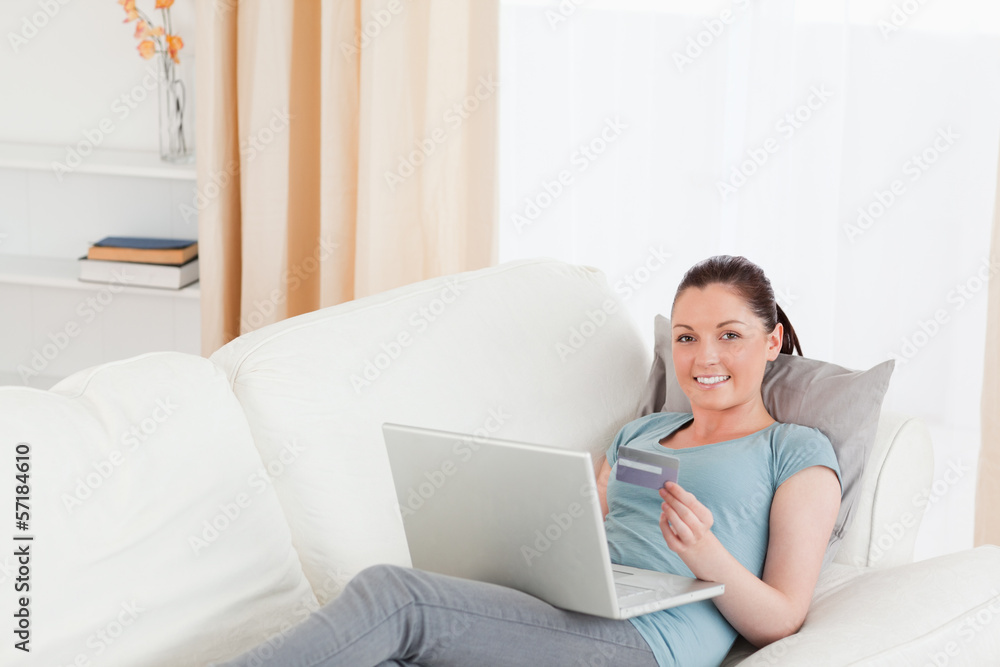 Gorgeous female making an online payment with her credit card wh Gorgeous female making an online payment with her credit card wh