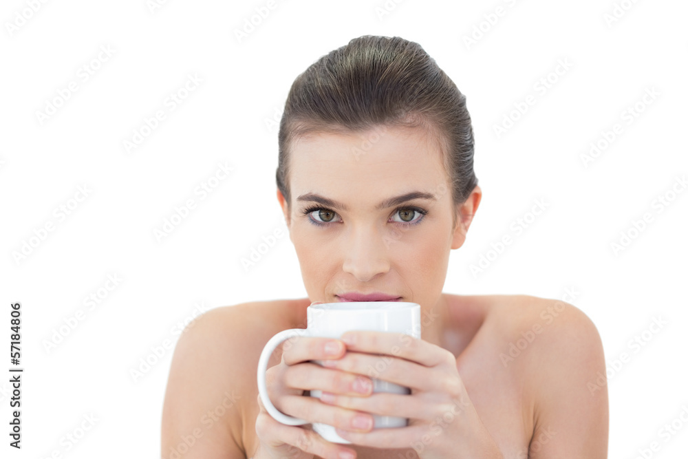 Shy natural brown haired model holding a mug of coffee Shy natural brown haired model holding a mug of coffee