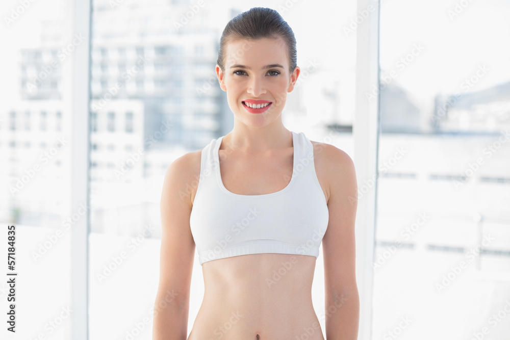 Attractive fit brown haired model in sportswear posing looking a Attractive fit brown haired model in sportswear posing looking a
