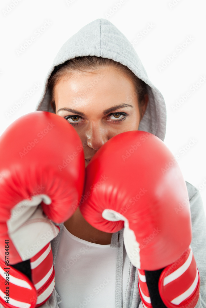 Female boxer with hoodie on in defensive stance Female boxer with hoodie on in defensive stance