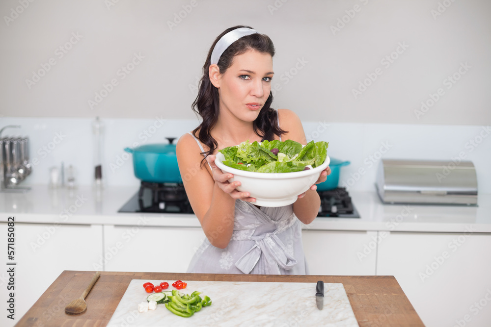 Smiling pretty brunette holding healthy salad Smiling pretty brunette holding healthy salad