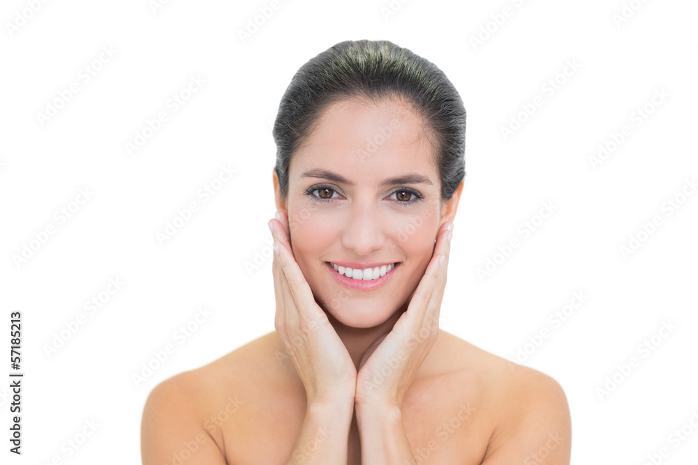 Smiling bare brunette touching her face Smiling bare brunette touching her face