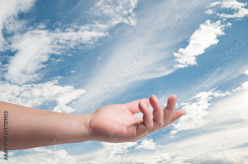 Hand Holding in sky background