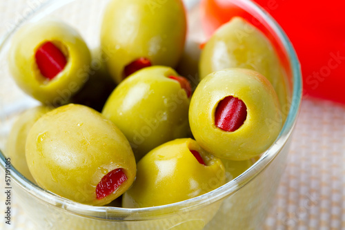 Green olives stuffed with red paprika