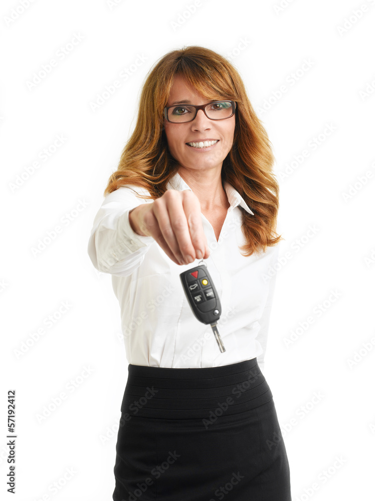 Businesswoman holding up car key Businesswoman holding up car key