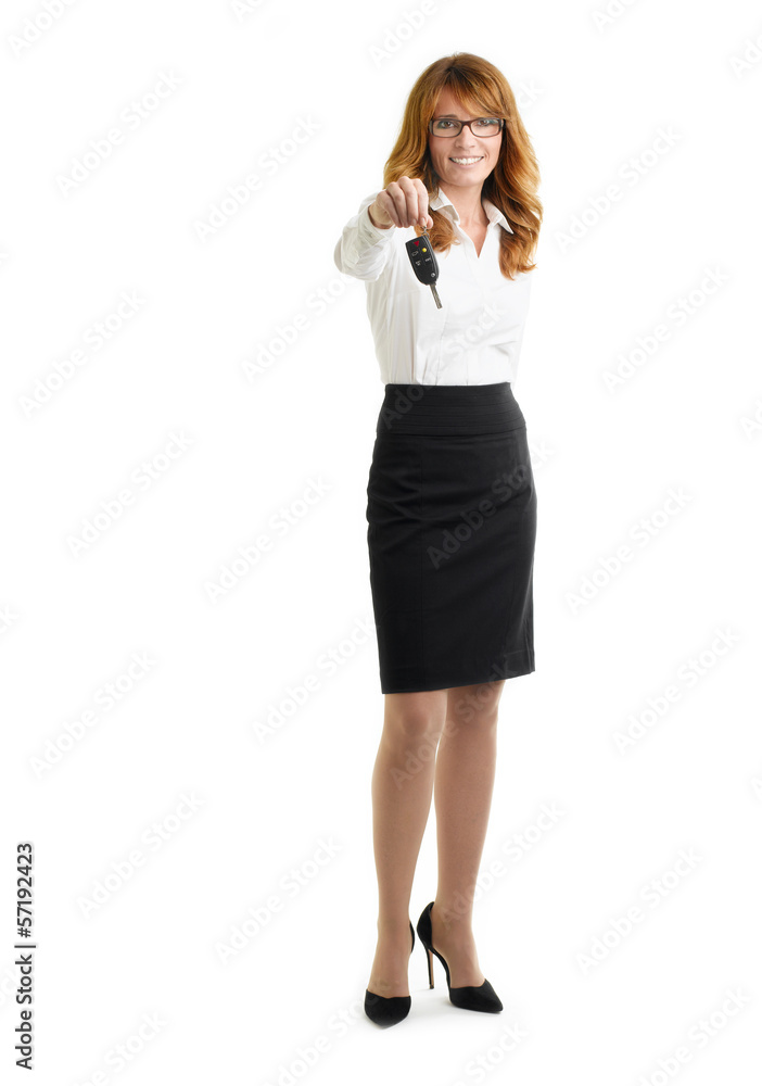 Businesswoman holding up car key Businesswoman holding up car key