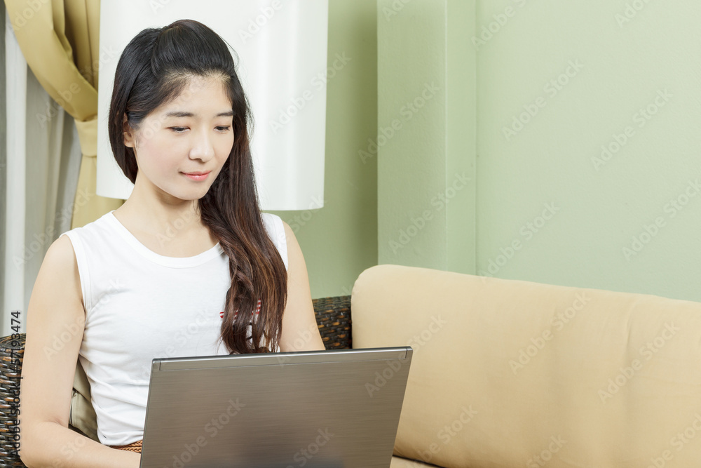Asian young business woman working on laptop or notebook Asian young business woman working on laptop or notebook