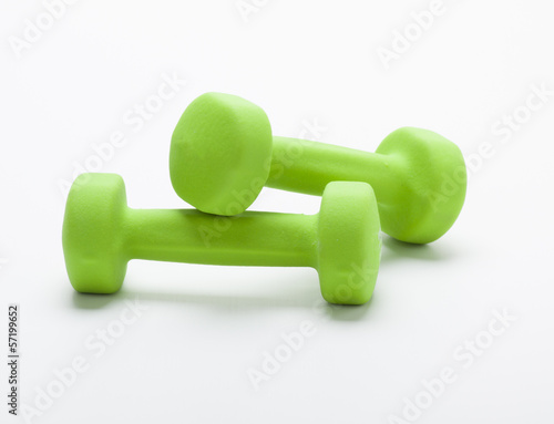 small green dumbbells, isolated in white