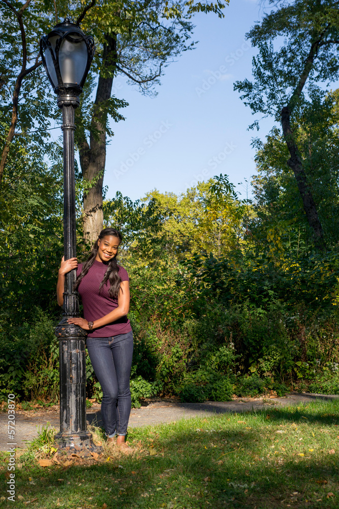 Fototapeta premium woman holding lamp post