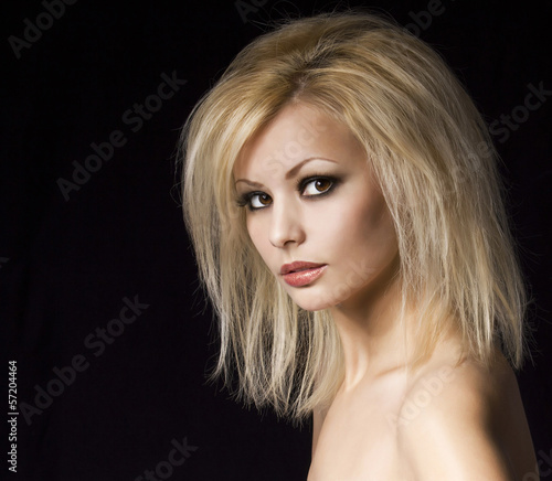 Fashion blonde woman with makeup and hairstyle over black