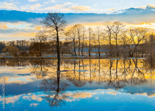 Evening dawn over spring flood of the river