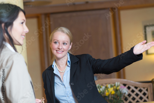 Valokuva Smiling receptionist helping a hotel guest