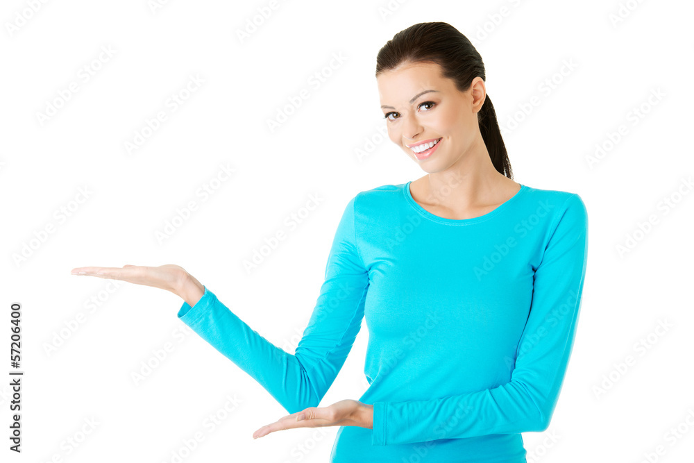 Happy , excited young woman showing on copy space Happy , excited young woman showing on copy space
