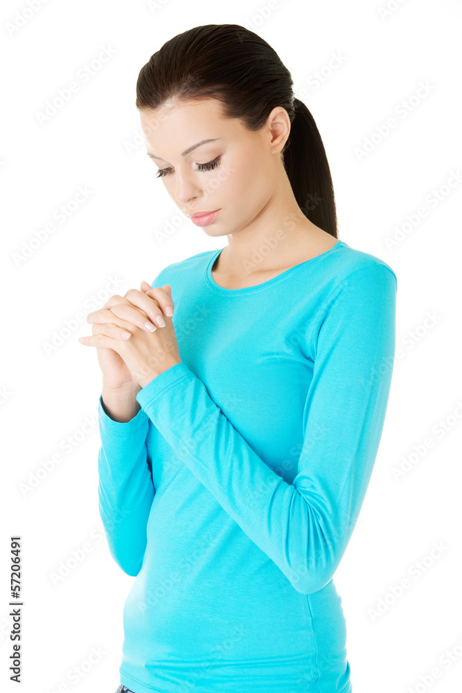 Closeup portrait of a young caucasian woman praying Closeup portrait of a young caucasian woman praying