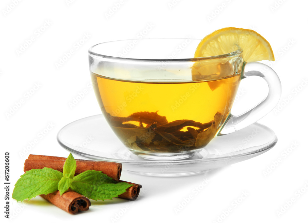 Transparent cup of green tea with cinnamon and mint isolated