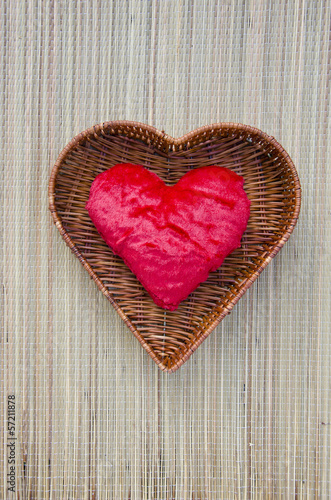 red cloth heart symbol in wicker basket