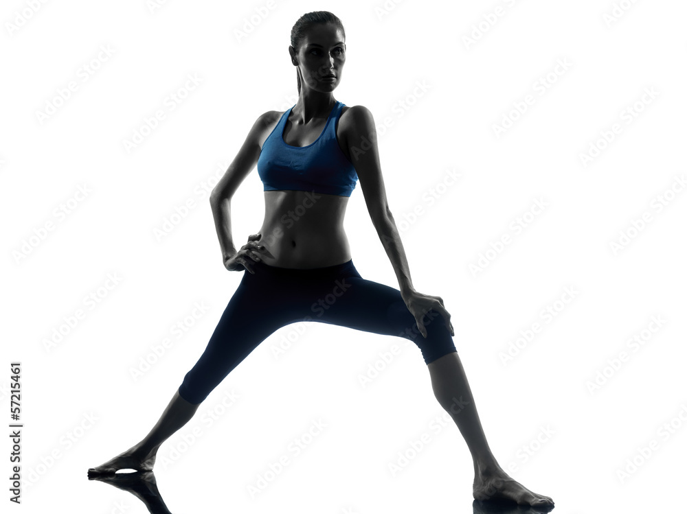 woman exercising yoga warrior position woman exercising yoga warrior position