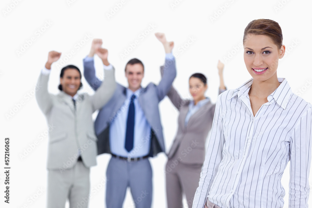 Close-up of a secretary smiling and business people with the thu Close-up of a secretary smiling and business people with the thu