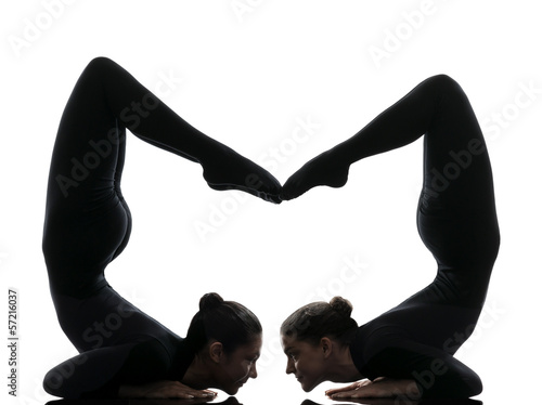 two women contortionist  exercising gymnastic yoga silhouette photo