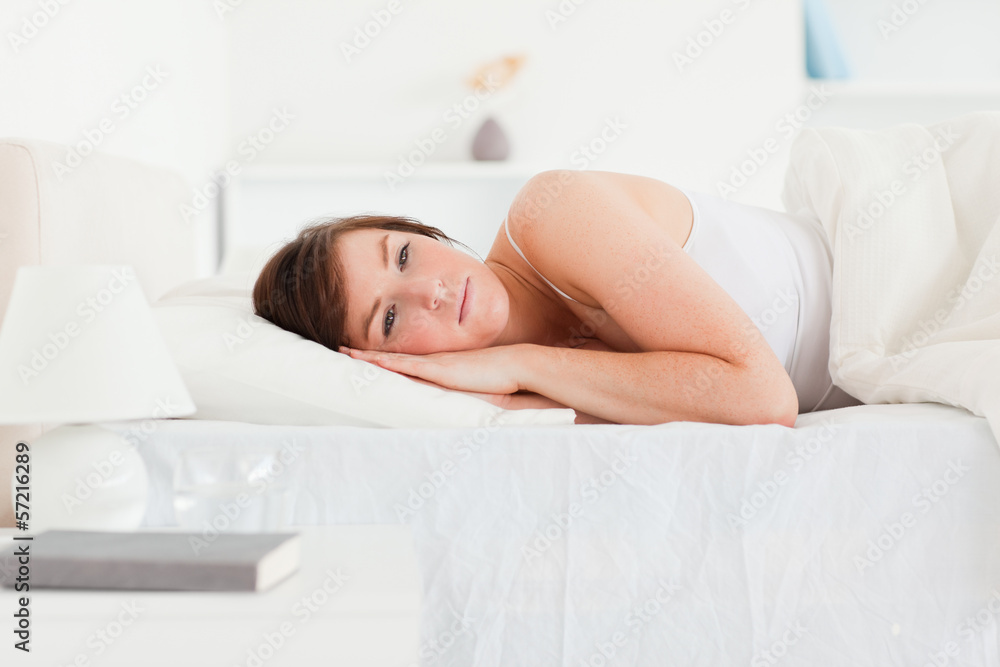 Lovely brunette female thinking while lying Lovely brunette female thinking while lying