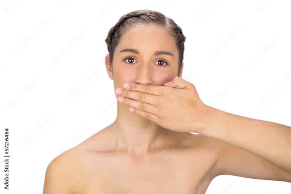 Unsmiling woman hiding her mouth Unsmiling woman hiding her mouth