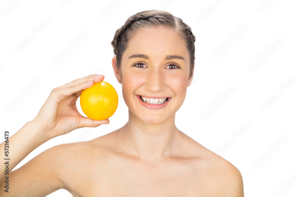 Smiling natural model holding orange Smiling natural model holding orange