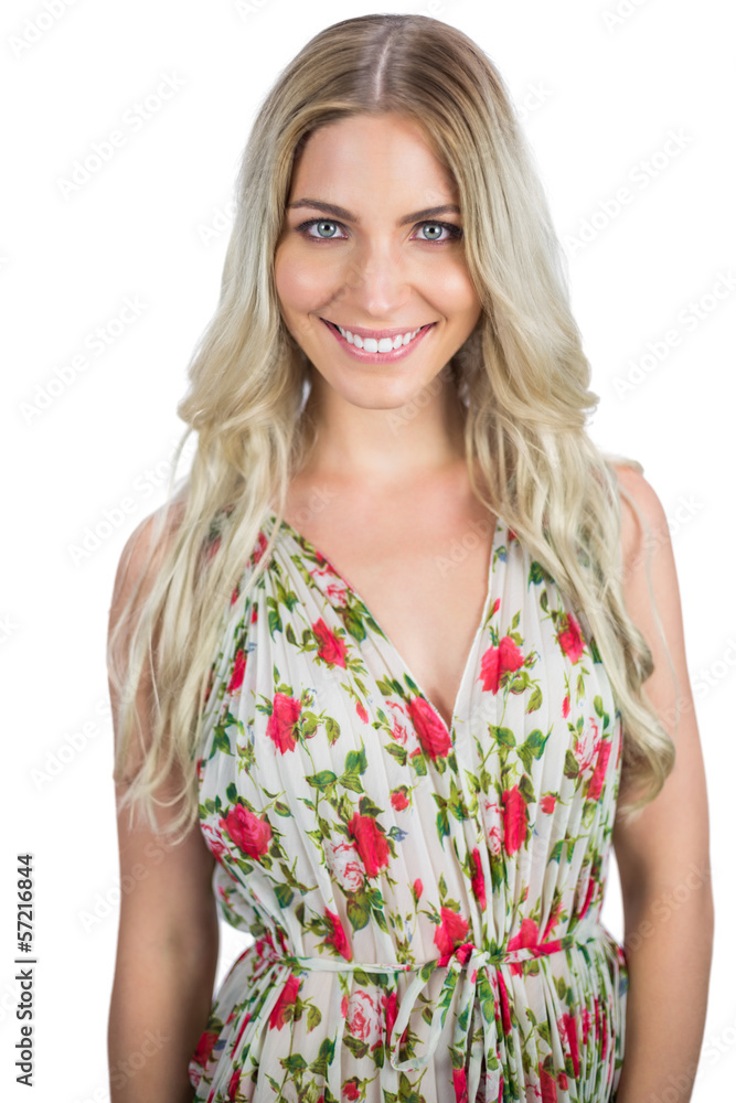 Cheerful blonde wearing flowered dress posing Cheerful blonde wearing flowered dress posing