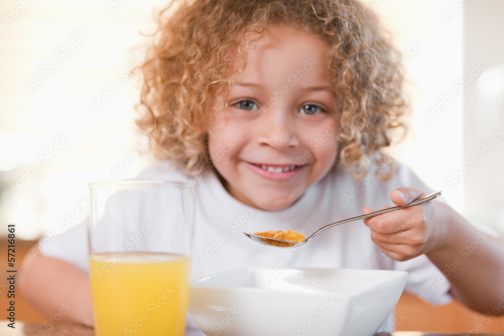 Smiling girl having breakfast in the kitchen Smiling girl having breakfast in the kitchen