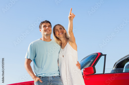 Smiling woman showing something to her handsome boyfriend