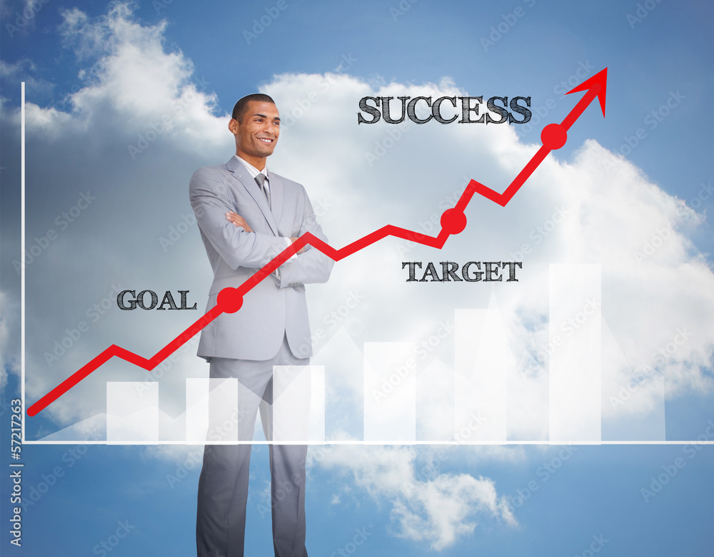 Cheerful businessman standing behind graphics Cheerful businessman standing behind graphics
