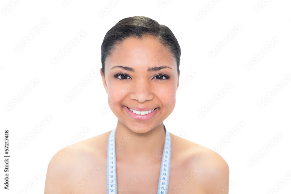 Playful young dark haired model wearing measuring tape around he