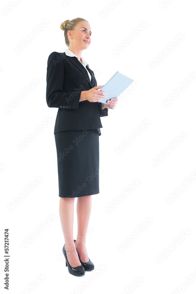 Low angle side view of businesswoman holding her tablet Low angle side view of businesswoman holding her tablet