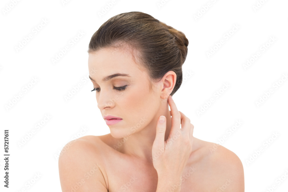 Serious woman touching her neck Serious woman touching her neck