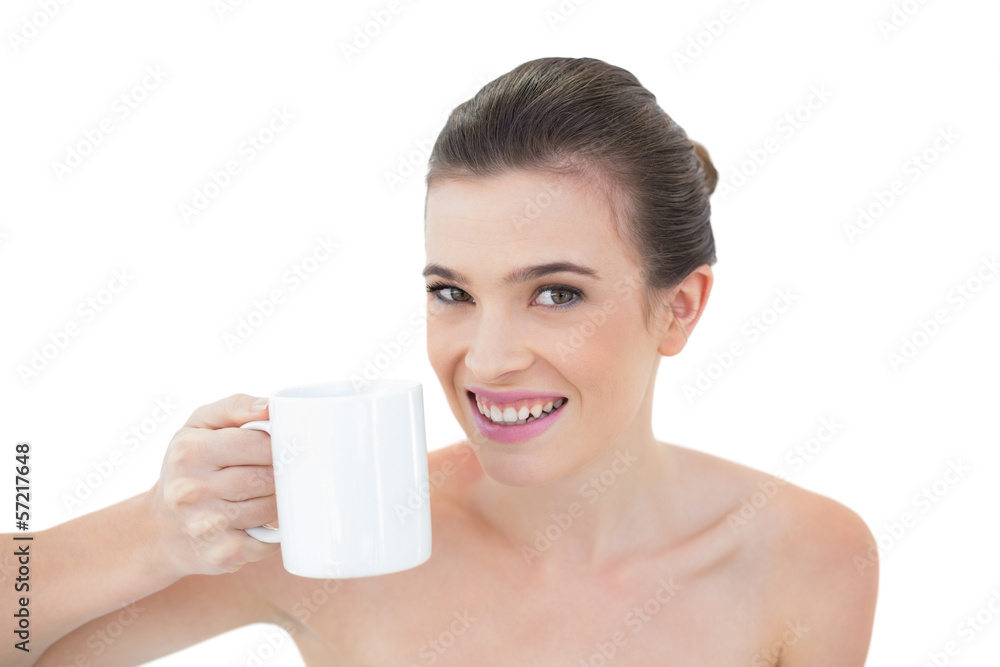 Joyful natural brown haired model holding a mug of coffee Joyful natural brown haired model holding a mug of coffee