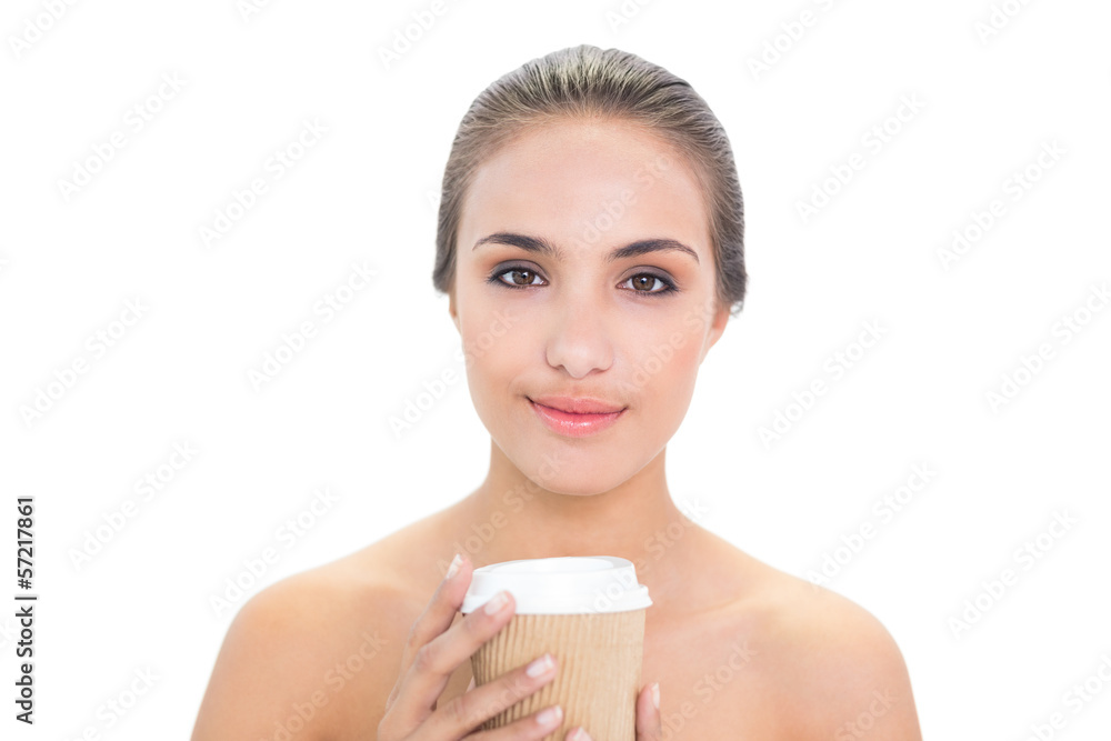 Content brunette woman holding a cup of coffee