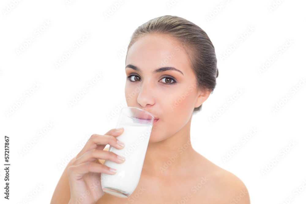 Content brunette woman drinking a glass of milk Content brunette woman drinking a glass of milk
