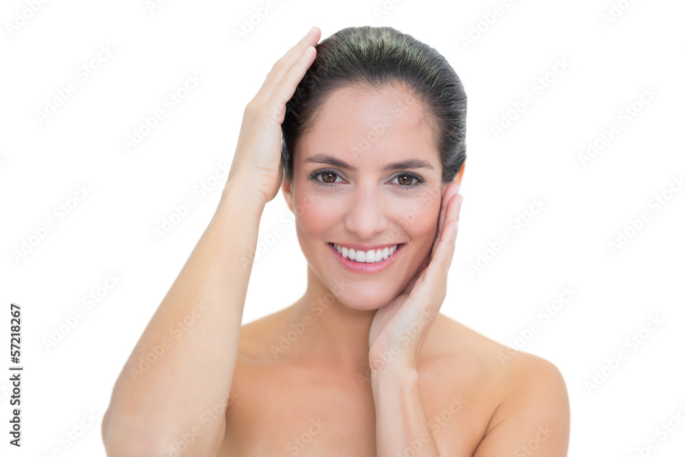 Smiling bare brunette touching her head Smiling bare brunette touching her head