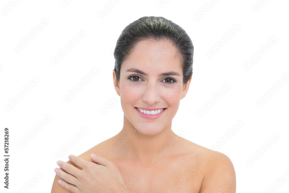 Smiling bare brunette touching left shoulder Smiling bare brunette touching left shoulder