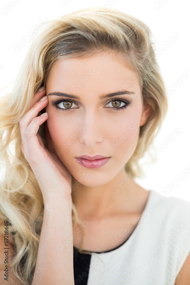 Serious attractive blonde model touching her temple Serious attractive blonde model touching her temple