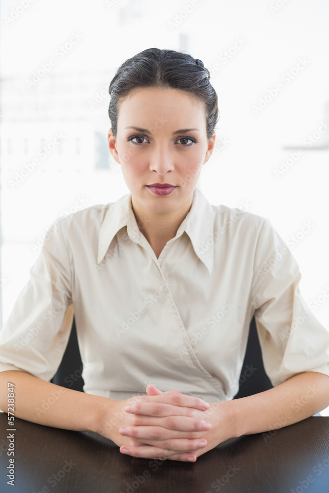 Serious stylish brunette businesswoman posing looking at camera Serious stylish brunette businesswoman posing looking at camera
