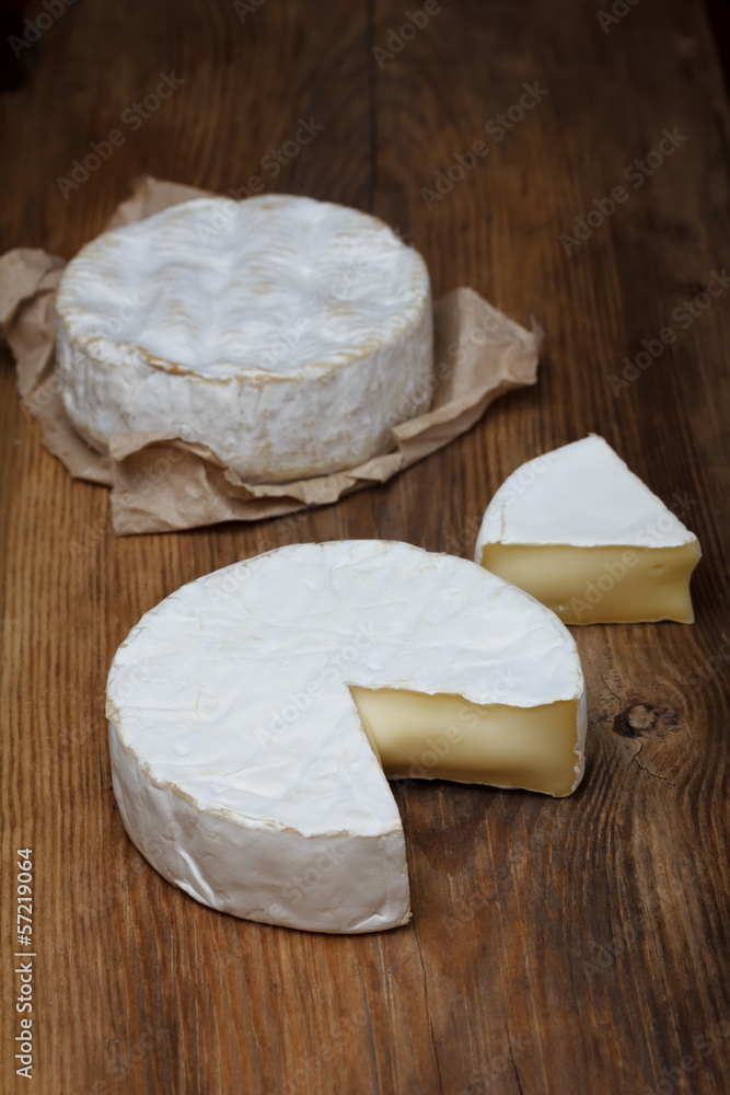 Camembert cheese on old wooden table Camembert cheese on old wooden table