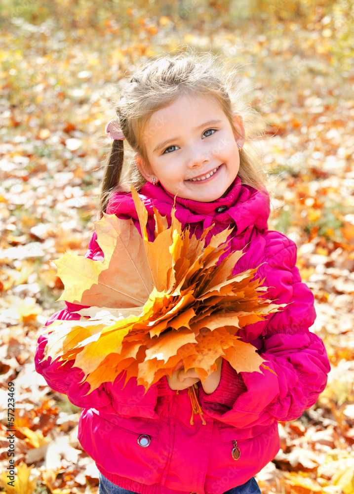 Autumn portrait of cute smiling little girl with maple leaves Autumn portrait of cute smiling little girl with maple leaves