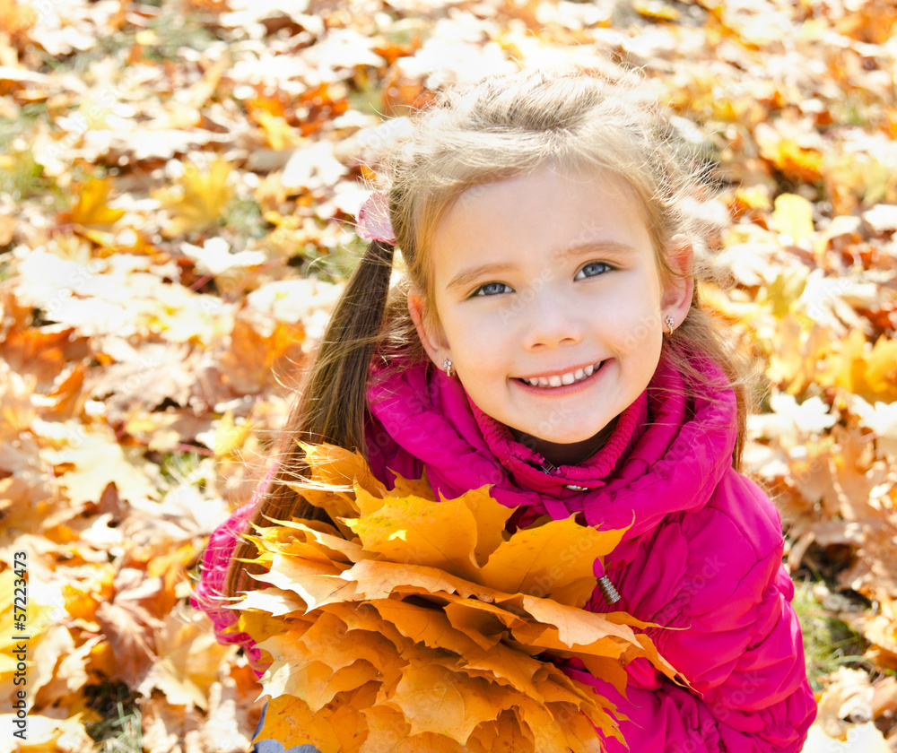 Autumn portrait of cute smiling little girl with maple leaves Autumn portrait of cute smiling little girl with maple leaves