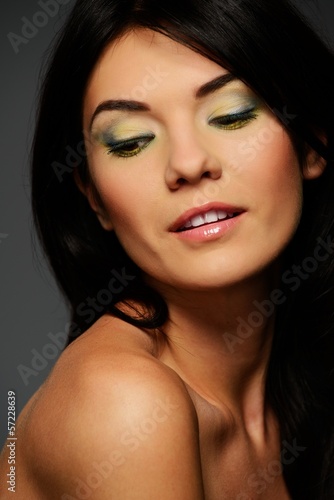 Portrait of a young beautiful brunette woman with make-up