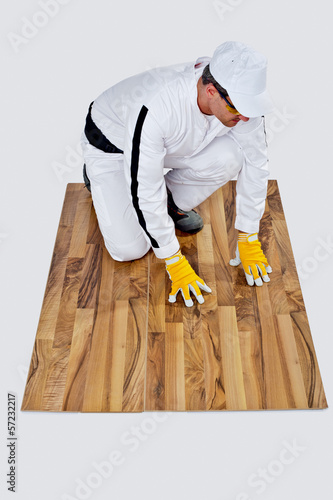 Worker Checks Old Wooden Floor For Cracks