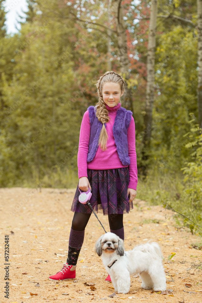 Charming little girl walking with puppy in park Charming little girl walking with puppy in park