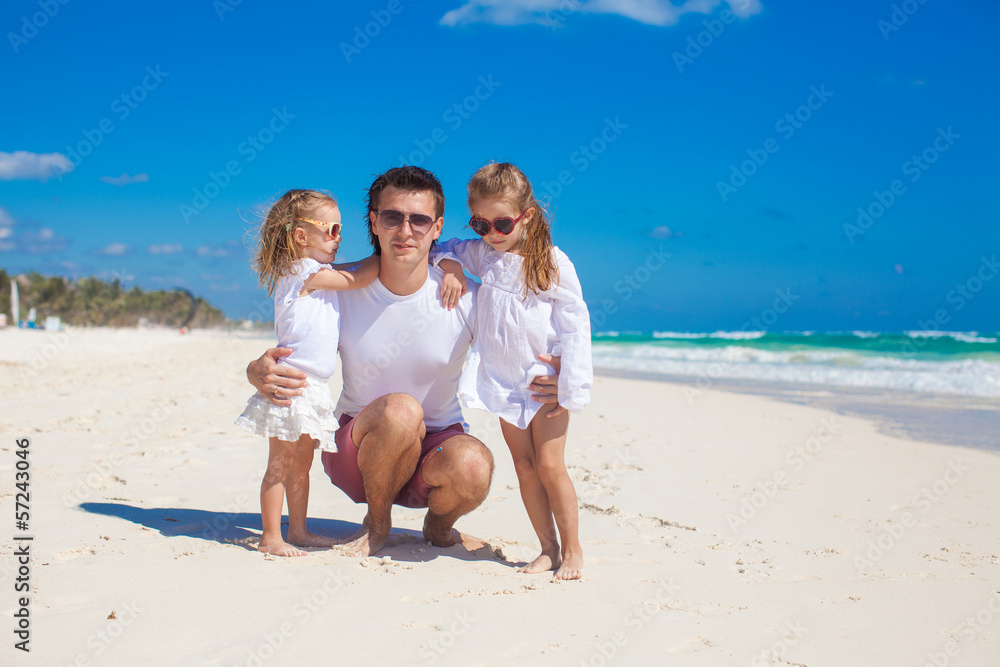 Young happy father and little daughters having fun on white Young happy father and little daughters having fun on white